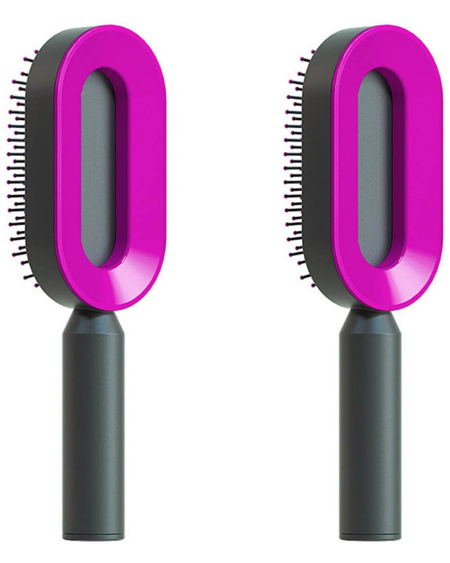 Two pet grooming brushes with pink handles and black bristle heads on a white background.