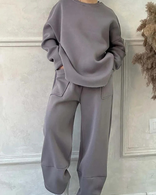 Women's autumn winter sweater trousers set in gray with pockets, featuring a loose round neck and long sleeves.