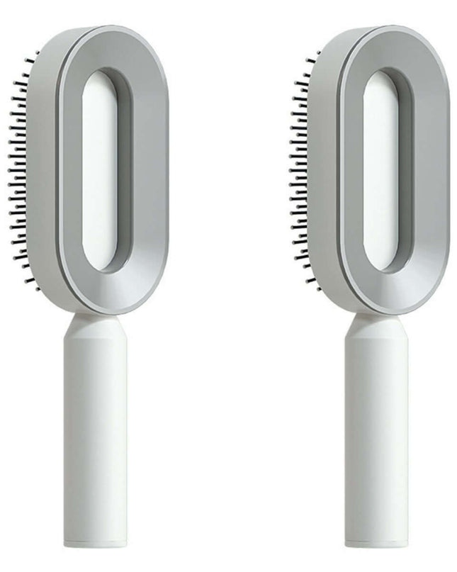 Two white grooming brushes with circular heads on a white background