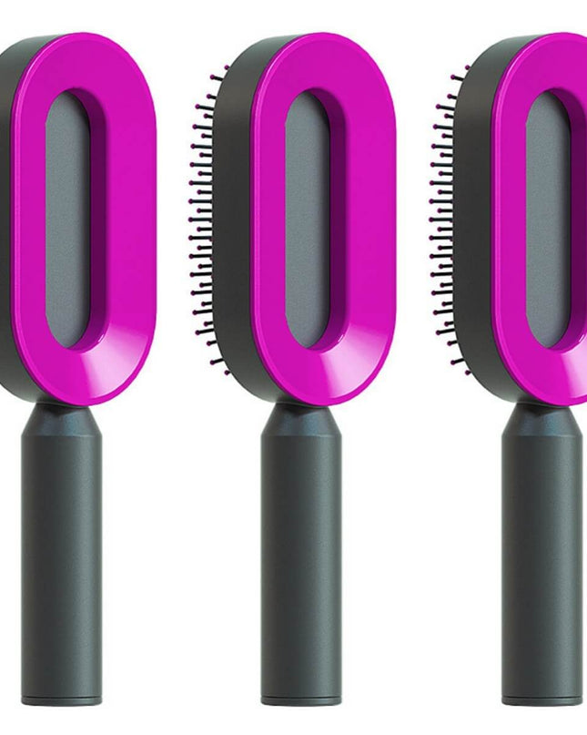 Three pet grooming brushes with pink handles and black bodies on a white background