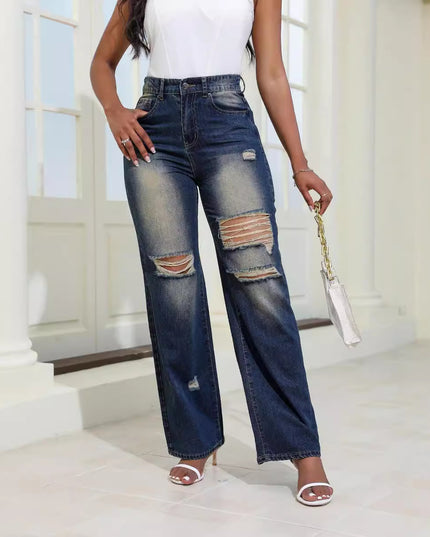 Person wearing ripped blue jeans in a bright indoor setting