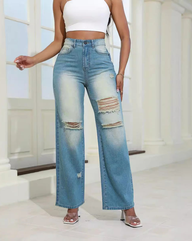 Person wearing light blue distressed jeans and a white top in a bright indoor setting.