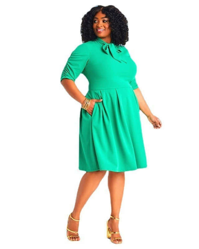 Woman wearing a green dress on a white background