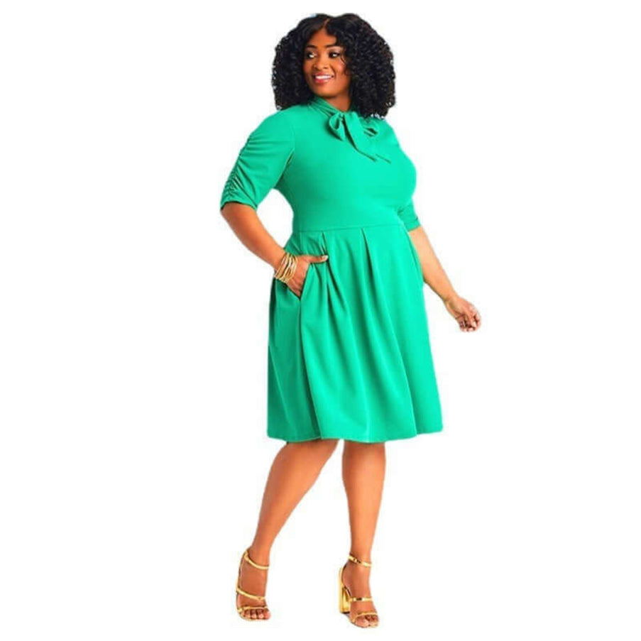 Woman wearing a green dress on a white background