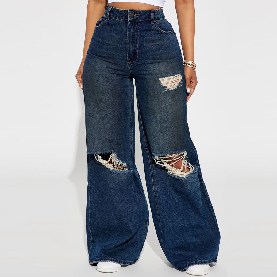 Wide-leg jeans with distressed details on a white background
