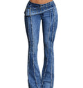 Blue jeans with decorative belt and stitching on a plain background