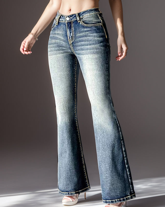 Flared jeans worn by a person on a gray background